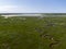 Aerial image of dutch national park slufter with curving rivers in grass land towards the north sea on the island of Texel