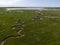 Aerial image of dutch national park the slufter with curving rivers in grass land towards the north sea on the island of Texel