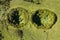 Aerial image of typical green volcanic caldera crater landscape resembling 2 eyes like a minion with volcano cones of Planalto da