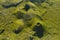 Aerial image of typical green volcanic caldera crater landscape with volcano cones of Planalto da Achada central plateau of Ilha