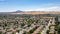 Aerial images over a community in Antioch, California with houses, cars, streets and trees. With a blue sky and room for text