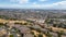 Aerial images over a neighborhood in Hayward, California with a blue sky and room for text