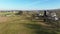 Aerial Inward View of Rich Harvested Farmlands With Barns, Silos and an Amish School House