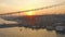 Aerial: Istanbul Bosphorus Bridge at Sunset, large freight ship sailing under