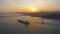 Aerial: Istanbul Bosphorus Bridge at Sunset, large freight ship sailing under