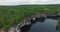 Aerial lake mirror with white cliff steep forestry bank