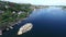 Aerial, lake and town in nature by port, peace and tranquil harbour for travel, water and island. Drone, river and