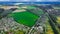 aerial landmark landscape photography from drone of suburban view with cottages and country side field in edge season of summer