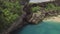 Aerial landscape cliff on rocky sea shore. Beautiful blue sea waves splashing by rocky cliff on coast. Turquoise ocean