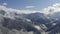 Aerial landscape cloudy haze over beautiful mountain valley on blue sky background. Gorgeous mountain view in misty haze from bird