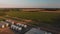 Aerial landscape of farm with a large modern plant for the storage and processing of grain crops. Summer landscape at sunset.