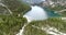 Aerial Landscape, Forest and Lake surrounded by Steep Mountains in the Alps 4K