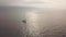 Aerial landscape golden morning sunrise and lonely sail boat sailing in sea