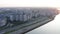 Aerial landscape golden sunset in city sky. Eveining city panorama from drone above. Urban architecture and highway in modern city