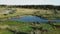 Aerial landscape of a lake surrounded by rural scene shot from a drone.