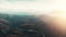 Aerial landscape panorama of morning sun and haze above beautiful mountains with curve road