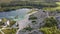 Aerial landscape Sand Hills of Quarry With a Pond and Abandoned Prison in Rummu Estonia Europe.