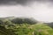 Aerial landscape showing bad weather over Caldeira do Alferes, a caldeira within the large volcano crater of Sete Cidades on SÃ£o