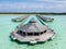 Aerial landscape view of the beautiful over water wooden hut in the ocean at the tropical island