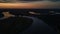 Aerial landscape view of curved river at sunset time