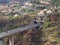 Aerial landscape view of the motorway bridge in funchal entering a tunnel in the valley with buildings and streets of the city