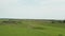 Aerial Landscape View Rising over a vast grassland under a cloudy sky