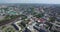 Aerial large city on river banks under blue sky in summer