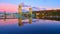 Aerial of lift bridge in Houghton over the lake with fall trees and a city during sunrise