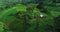 Aerial: Little wooden hut on a green hill in the mountains.