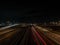 Aerial long exposure shot of car light trails on the city road at night