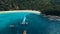 Aerial: Long tail boats on the white sand beach.