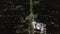 AERIAL: Lookup over Wilshire Boulevard Street in Hollywood Los Angeles at Night with View on Downtown and Glowing