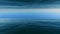 Aerial low altitude Fly above Ocean Water Surface with Blue Sea Ripples And Waves. Horizon endless view