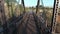 Aerial, low, drone shot through a small, steel bridge, in California