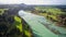 Aerial of a lush green valley with a serene river winding through it