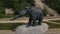 Aerial: Mammoth statues, reconstruction of prehistoric times
