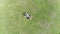 Aerial of man lying on grass, extreme zoom-out, Earth globe