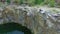 Aerial: Man takes photos on peak of rock