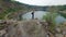 Aerial: Man takes photos on peak of rock