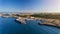 Aerial. The maritime dock in the Portuguese city of Sines and the sailboat is moored for tourist excursions. Blue ocean