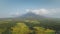 Aerial Mayon volcano eruption at green valley. Rural fields at farmlands at nobody nature landscape