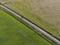 Aerial of meadowland separated by straight bicycle lane on the dutch island of Texel