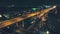 Aerial, modern city traffic intersection night. Illuminated motorway with car. District Kuala Lumpur