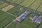 Aerial of modern farms with solar panels on the roof in dutch meadow landscape