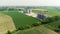 Aerial: modern industrial plant for agriculture produce processing and storage, cereal corn grain wheat crop fields.