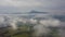 Aerial morning mountains view in the fog in the Low Tatras with city on background