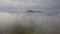 Aerial morning mountains view in the fog in the Low Tatras with city on background