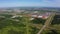 Aerial motion above highway with junction near plant