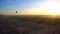 Aerial motion video riding hot air balloon over Luxor Egypt valley of the king Unesco heritage site sunrise