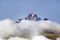 Aerial of Mount Kenya, Africa with snow and white puffy clouds in January, the second highest mountain at 17,058 feet or 5199 Mete